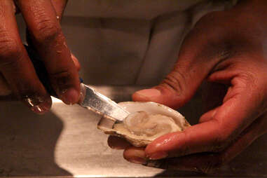 Shucking a Mayflower oyster at a.bar's happy hour