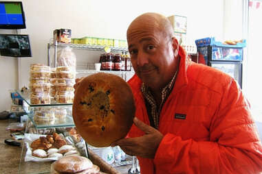 Andrew Zimmern holding some giant bread
