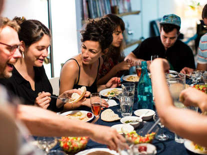 People sitting around a table at a dinner party