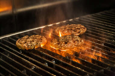 Cooking the beef patty for the Supreme Nacho Burger at Slater's 50/50 in Liberty Station San Diego.