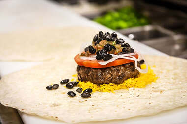 The veggies are piled on the Supreme Nacho Burger at Slater's 50/50 in Liberty Station San Diego.