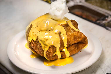 The Supreme Nacho Burger is topped with a dollop of sour cream at Slater's 50/50 in Liberty Station San Diego.