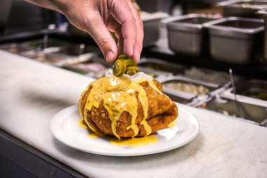 Jalapenos are the final topping on the Supreme Nacho Burger at Slater's 50/50 in Liberty Station San Diego.