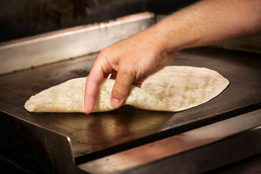 Warming up the tortilla for the Supreme Nacho Burger at Slater's 50/50 in Liberty Station San Diego.