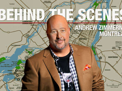 Andrew Zimmern in front of a map