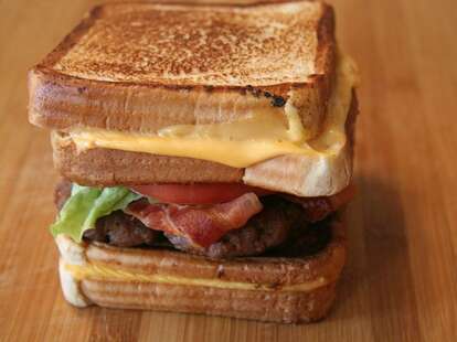 Burger between two grilled cheese sandwiches
