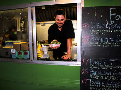 food truck man holding sandwich