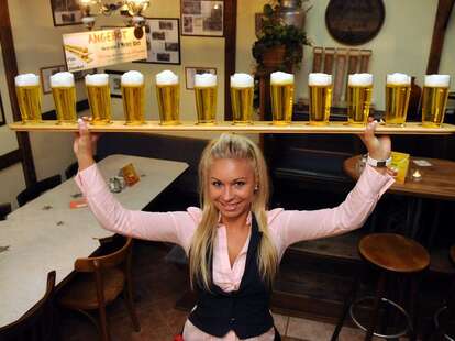 Woman holding many beers