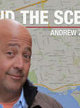 Andrew Zimmern in front of a map