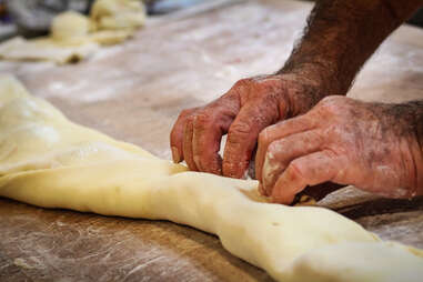 Rolling the ham and cheese in dough to make the monte cristo sandwiches at Donut Bar in downtown San Diego.