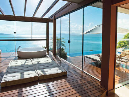 Bathroom with skylight and glass walls overlooking the water