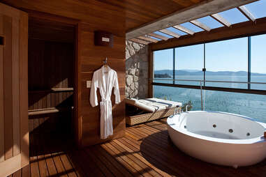 bathtub with robe and view of ocean