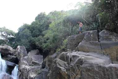 Dude standing at the top of a cliff